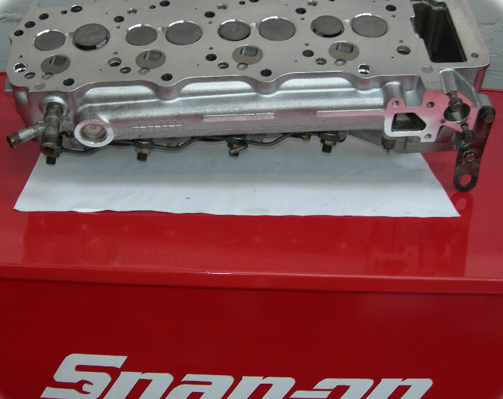 Reconditioned cylinder head on a workshop tool chest